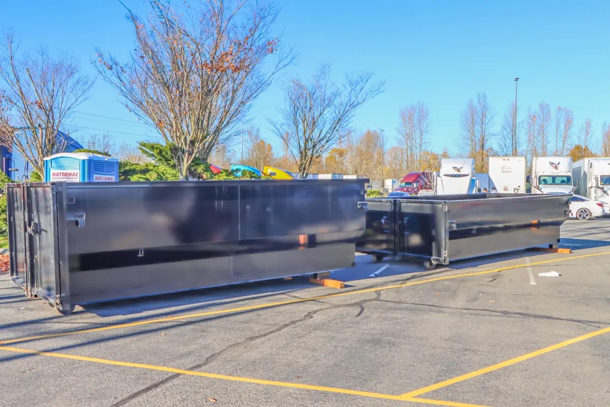 Professional dumpster rental service with roll-off container on residential driveway in Newberry
